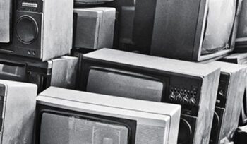 Stack of old CRT televisions and speakers piled together, representing obsolete electronics and the growing e-waste challenge.