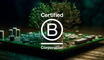 Certified B Corporation logo over an image of a green circuit board with a tree growing from it, symbolising sustainability and technology.