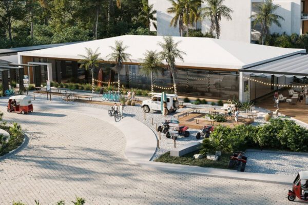 Resort entrance with palm trees and paved driveway made using Resin8 blocks and pavers in Mexico, Costa Rica, and South Africa, showcasing practical e‑waste solutions for sustainable infrastructure.