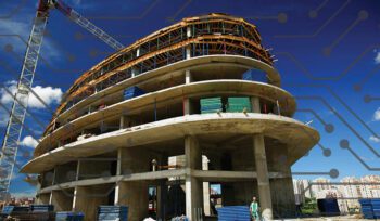 Partially built multi-story concrete structure with scaffolding and a crane, used to illustrate federal procurement policy blog.