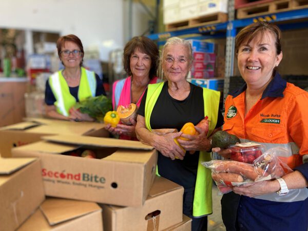 second bite image 02 Second Bite food rescue team with donated produce in a warehouse environment, promoting sustainable solutions, circular economy initiatives and e‑waste solutions in Australia