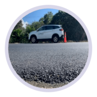 Close‑up view of asphalt road surface demonstrating e‑waste solutions used in recycled road construction.