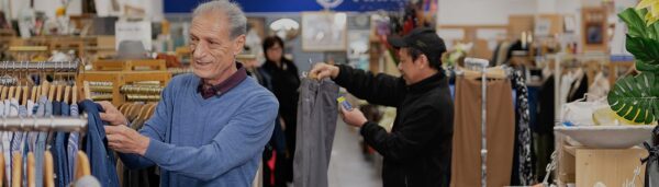 charitable reuse australia people browsing through clothing racks People browsing clothing racks in a Charitable Reuse Australia store, promoting reuse to reduce e‑waste.
