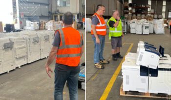 Warehouse with large printers and copiers stacked on pallets for recycling, showcasing soft plastic and hard plastic circularity processes in Australia as part of sustainable e-waste management.