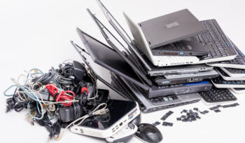 E‑waste recycling solutions showing laptops, cables and electronic devices ready for responsible processing